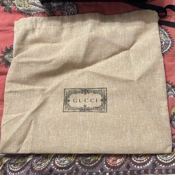 Tan gucci belt, with gold gucci sign, and black and brown gucci imprint on it. - Picture 11 of 11